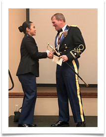 LTC Thomas Brede presents the Col. Ed Ramsey Scholarship Endowment Award to Cadet Kelly Vu